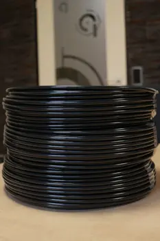 A stack of regranulated tubing coils in black.