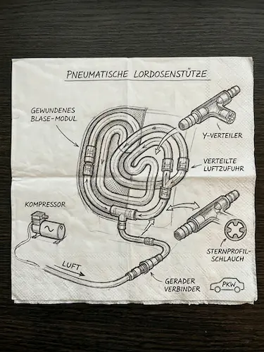 Skizze eines Schlauchsystems für eine Lordosenstütze auf einer Serviette.